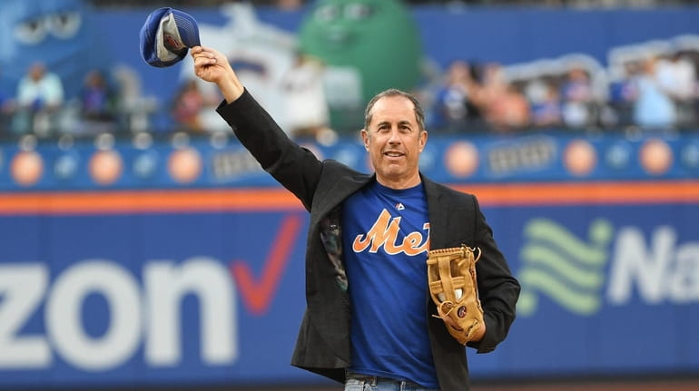 Comedian Jerry Seinfeld waves to fans before throwing a ceremonial...