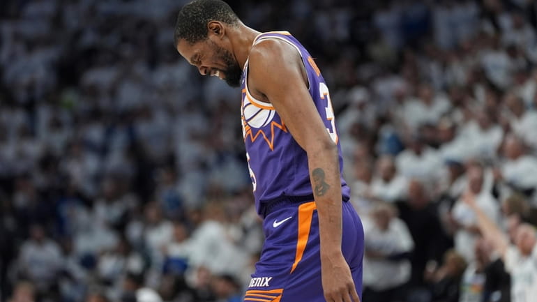 Phoenix Suns forward Kevin Durant walks across the court during...