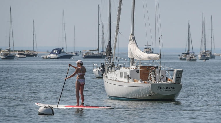 Diana Feirstein of Coram paddles her standup paddleboard in Port...
