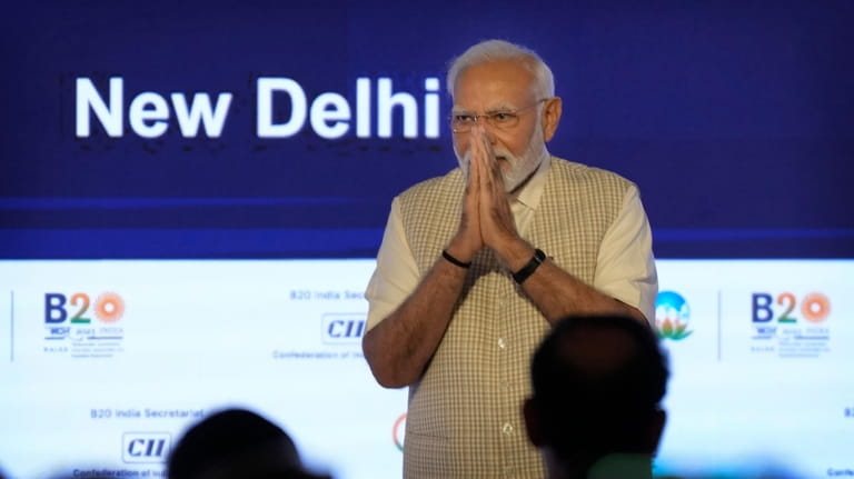 Indian Prime Minister Narendra Modi greets delegates after speaking at...