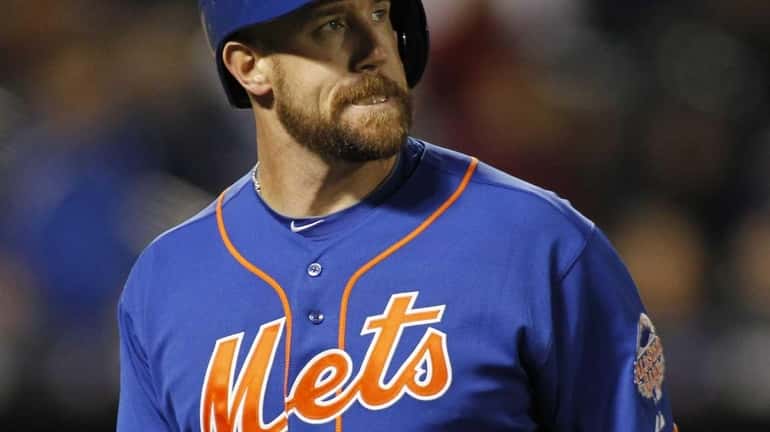 Mets hitter John Buck reacts after flying out to left...