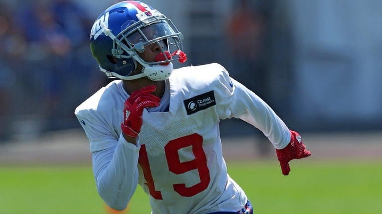 Giants wide receiver Travis Rudolph tracks a punt during training...