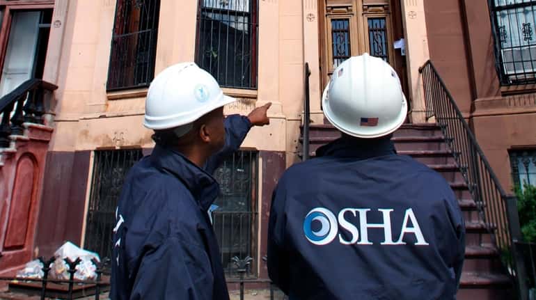 OSHA inspectors survey homes in Brooklyn that lost roofs in...