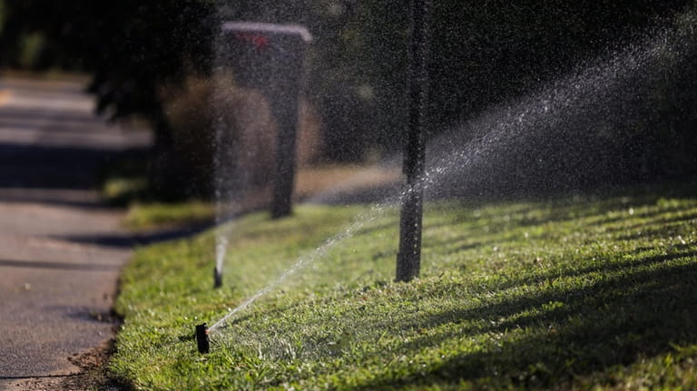Sprinklers in operation along South Country Road in Bellport on...