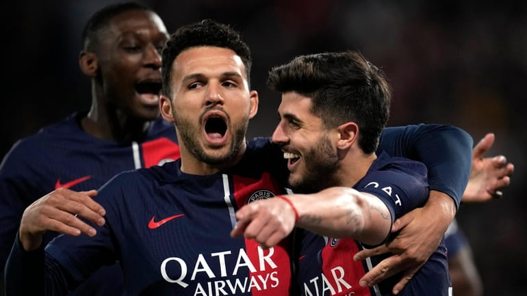 PSG's Lucas Beraldo, left, celebrates with PSG's Goncalo Ramos after...