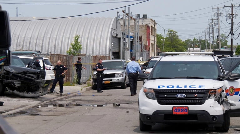 Nassau police investigate at the crash scene Wednesday at Industrial...
