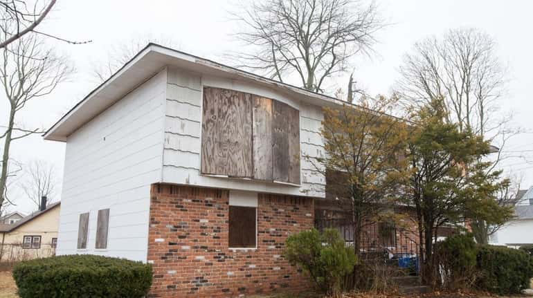Plywood covers the windows of an abandoned home in Massapequa...