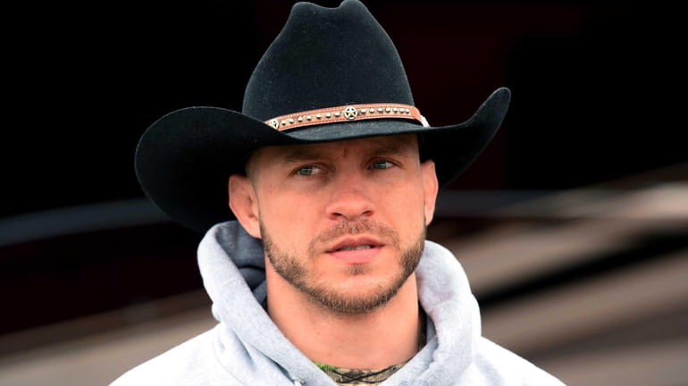 Donald Cerrone looks on as he presents NASCAR driver Kevin...