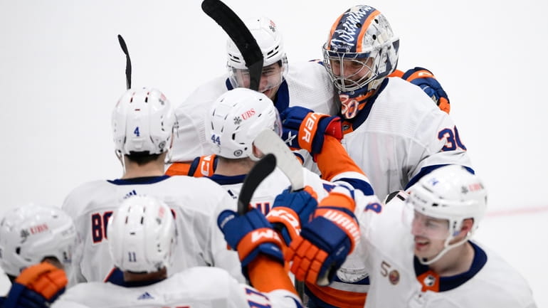 Islanders goaltender Ilya Sorokin celebrates with teammates after an NHL...