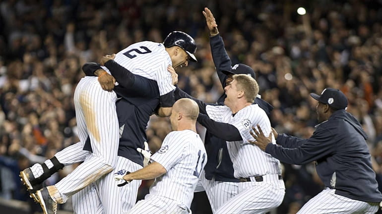 Yankees' Derek Jeter gets a big hug from CC Sabathia...