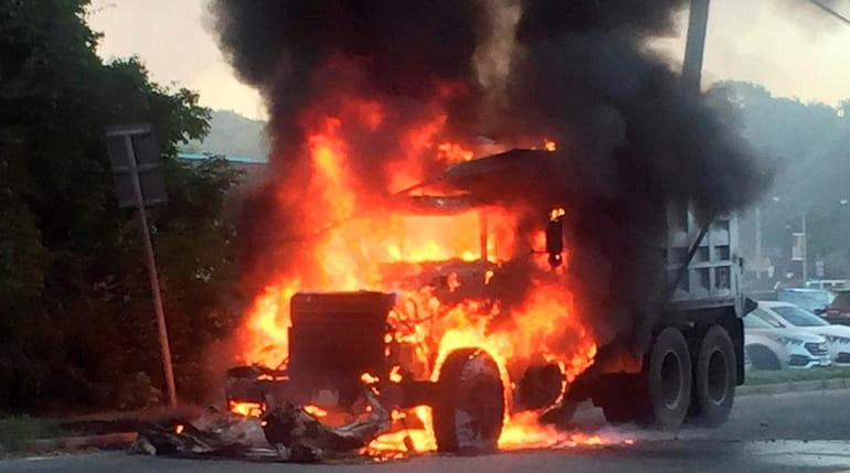 Flames engulf a 10-wheel dump truck on Park Avenue in...