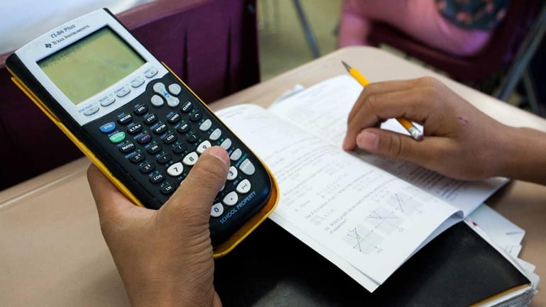 A student in a ninth-grade algebra class at Center Moriches High...