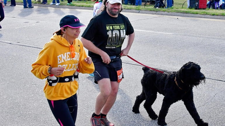 A man runs the half-marathon with his dog on Charles...