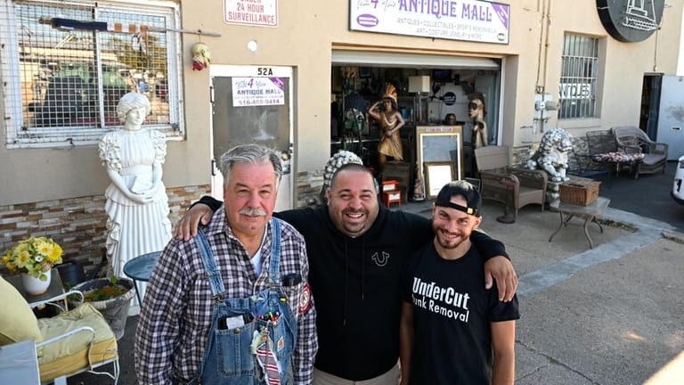 Wally Stack, center, owner of This 4 You in Freeport, with...