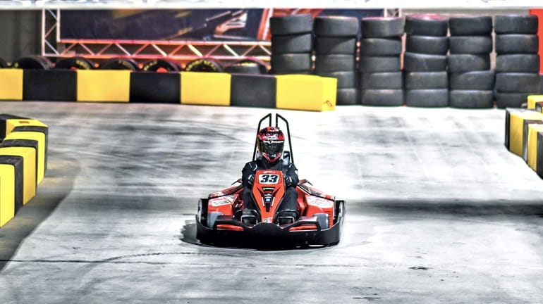 An electric go-kart racer stands by to make a run at...