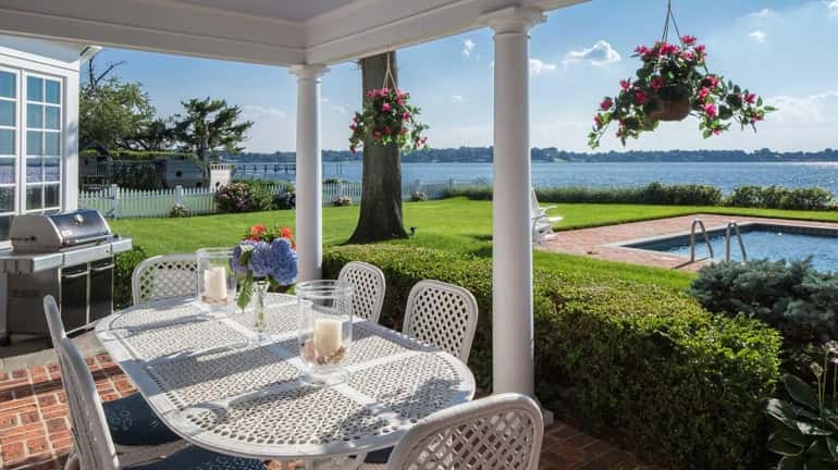 The six-bedroom Sands Point Colonial features water views from every...