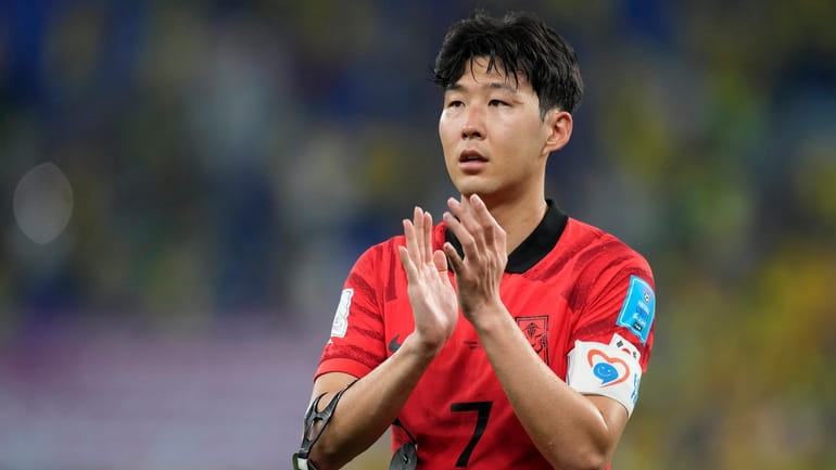 South Korea's Son Heung-min applauds the fans after losing 4-1...