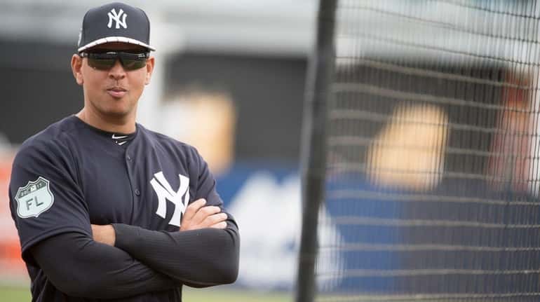 Former New York Yankees third baseman Alex Rodriguez looks on...