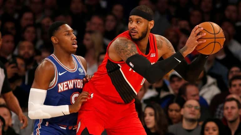 Carmelo Anthony of the Portland Trail Blazers works against RJ Barrett of the...