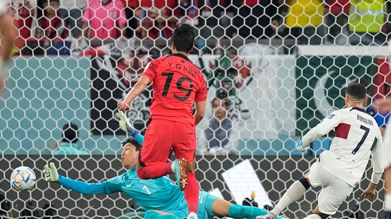 South Korea's goalkeeper Kim Seung-gyu makes a save shot by...
