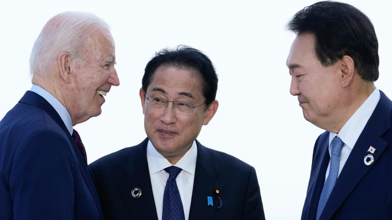 President Joe Biden, left, talks with Japan's Prime Minister Fumio...