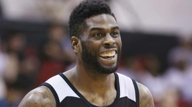 The Brooklyn Nets' Willie Reed laughs during a pause in...