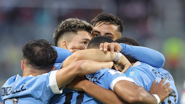 Uruguay's players celebrate their side's opening goal against United States...
