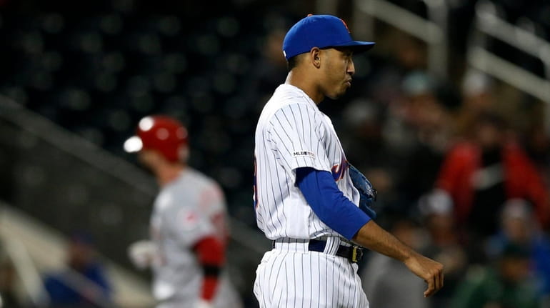 Edwin Diaz #39 of the Mets looks on after surrendering...