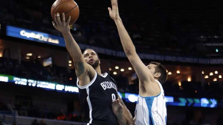 Nets guard Deron Williams drives to the basket against New...
