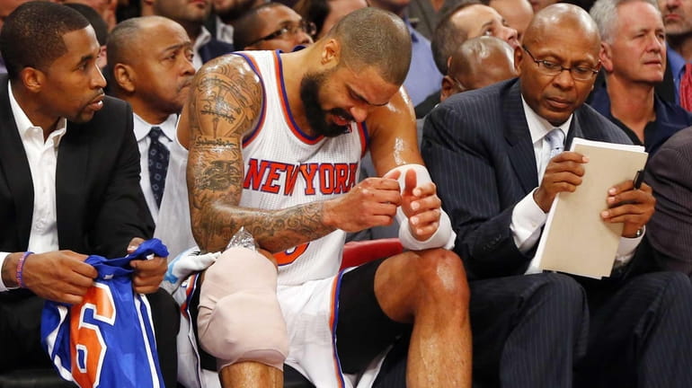 Tyson Chandler sits on the bench after suffering an injury...