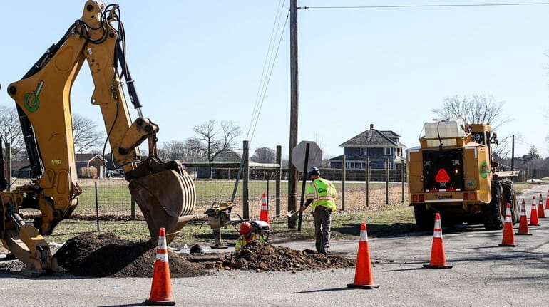 Construction crews perform electrical work on Wainscott Main Street in...