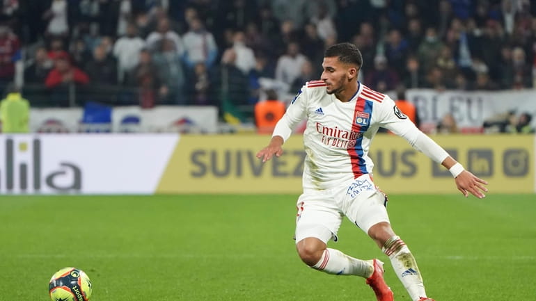 FILE - Lyon's Houssem Aouar controls the ball during the...