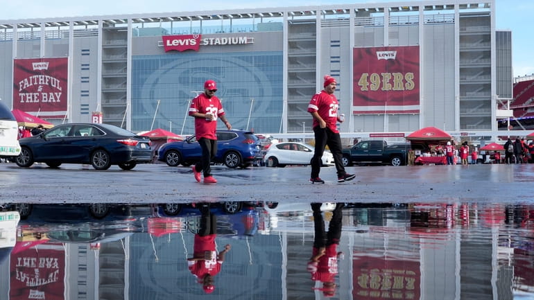 Fans walk outside Levi's Stadium before an NFL football game...