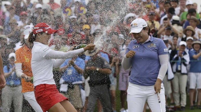 Inbee Park is sprayed with champagne after sinking her last...