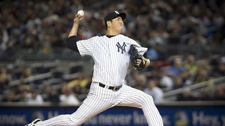 Yankees pitcher Hiroki Kuroda throws in the top of the...
