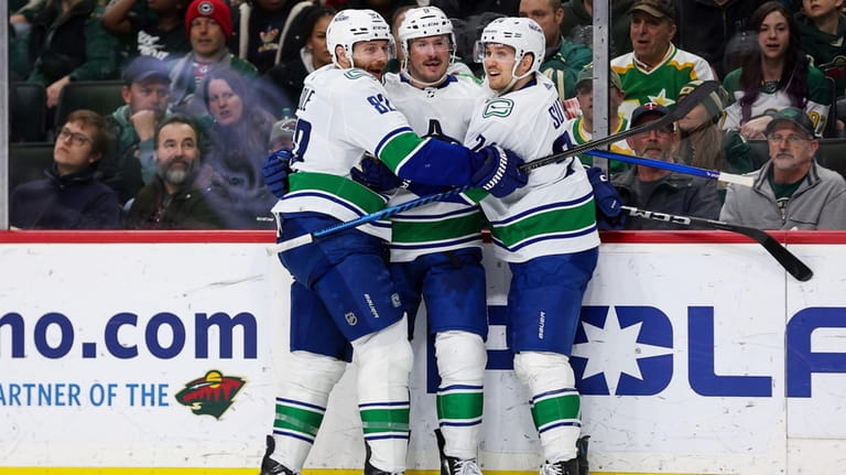 Vancouver Canucks center J.T. Miller is congratulated for his hat-trick...