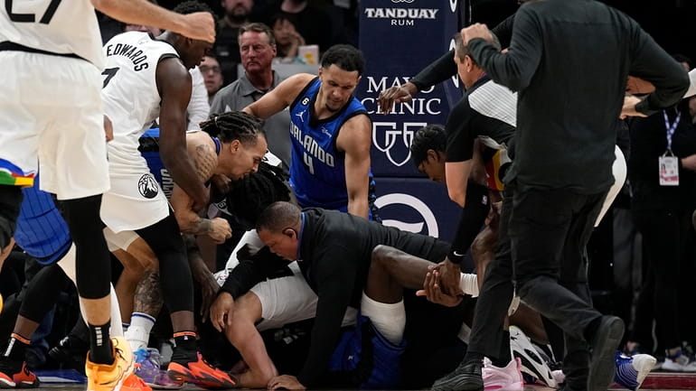 A scrum breaks out between Timberwolves and Magic players during...