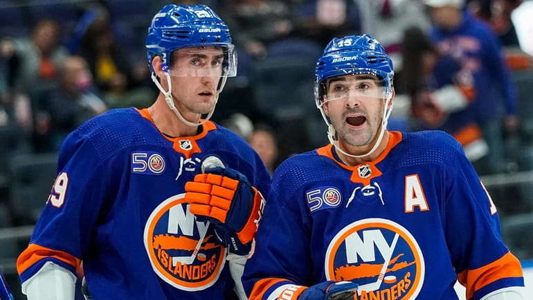 Islanders centerman Brock Nelson and right wing Cal Clutterbuck speak during...