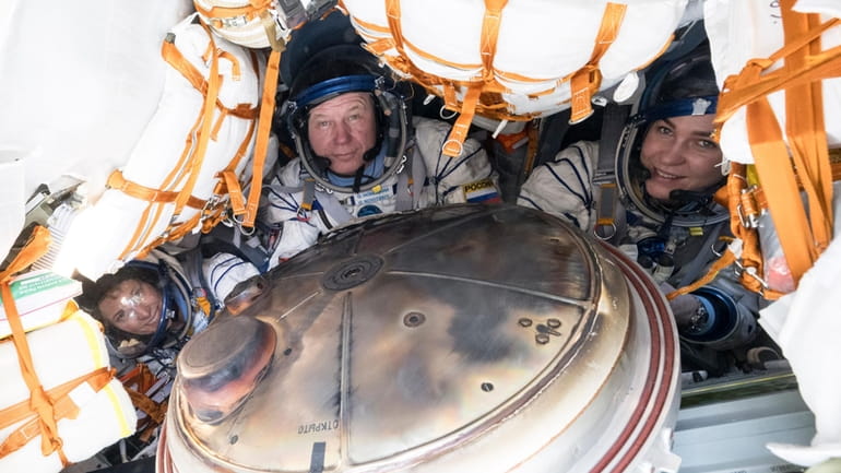 NASA's Loral O'Hara, left, Russia’s Oleg Novitsky and Belarus spaceflight...