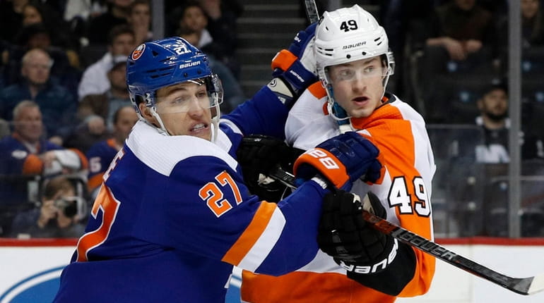 Anders Lee of the Islanders battles for position during the...