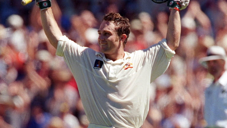 Australia Cricketer Michael Slater left, celebrates hitting a century during...