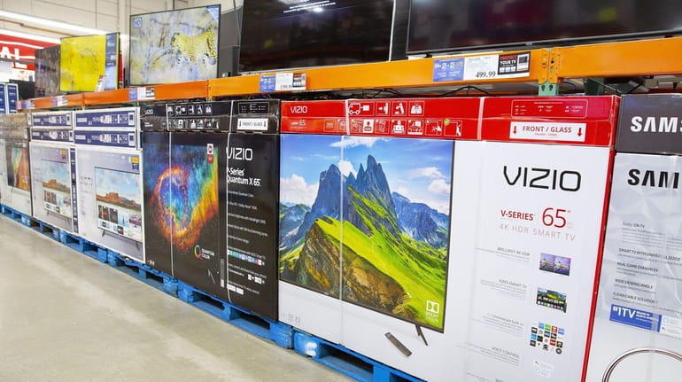 Large televisions on display at a Costco Club store in...