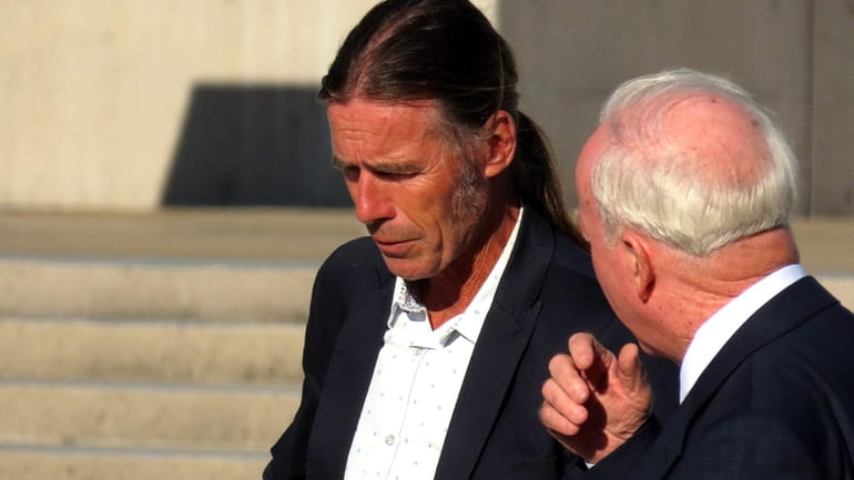 Montauk fisherman Christopher Winkler confers with his lawyer, Peter Smith...