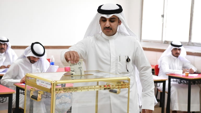 A man casts his vote for National Assembly elections at...