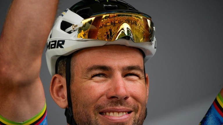 Britain's sprinter Mark Cavendish, known as the Manx Missile, greets...