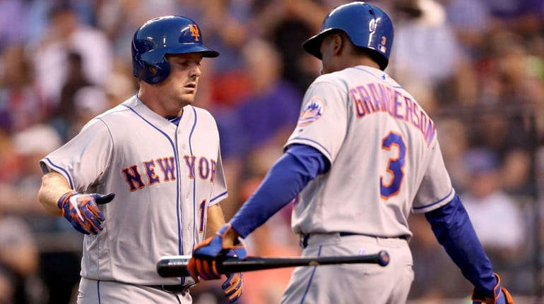 Jay Bruce of the Mets is congratulated by Curtis Granderson...