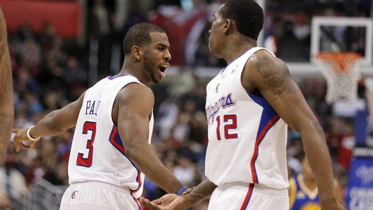 Los Angeles Clippers point guard Chris Paul, left, celebrates a...