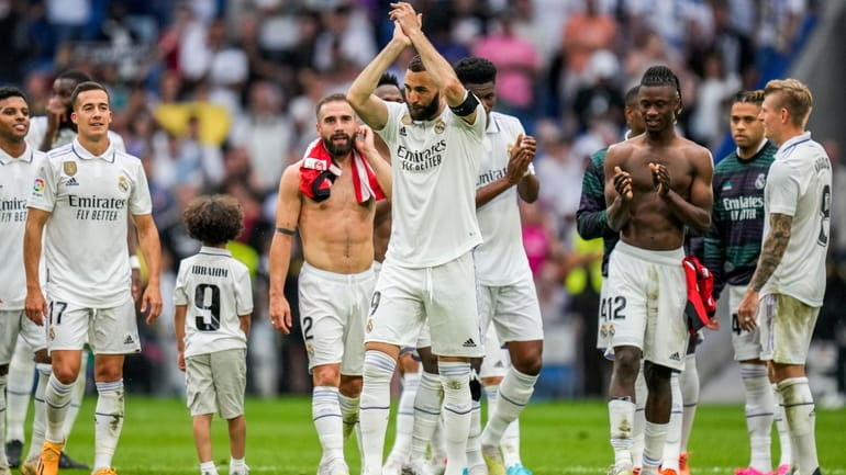 Real Madrid's Karim Benzema claps to supporters after the Spanish...