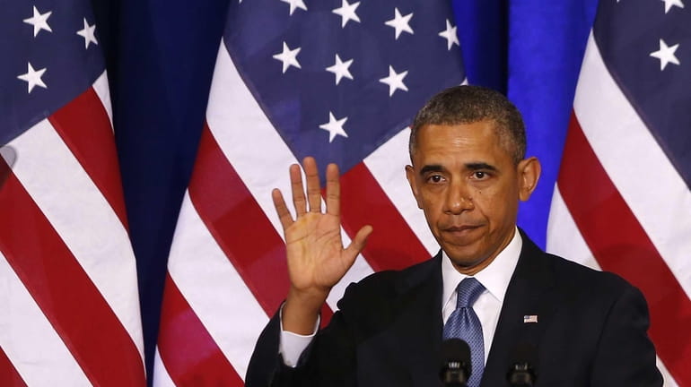 President Barack Obama waves to the audience after he spoke...