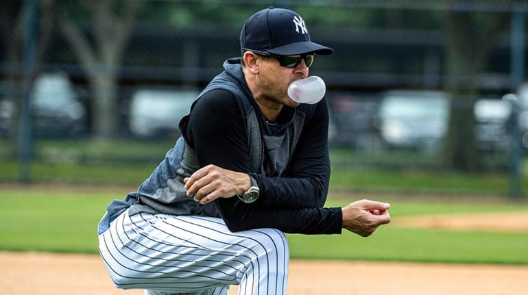 Yankees manager Aaron Boone watches drills during spring training in Tampa,...